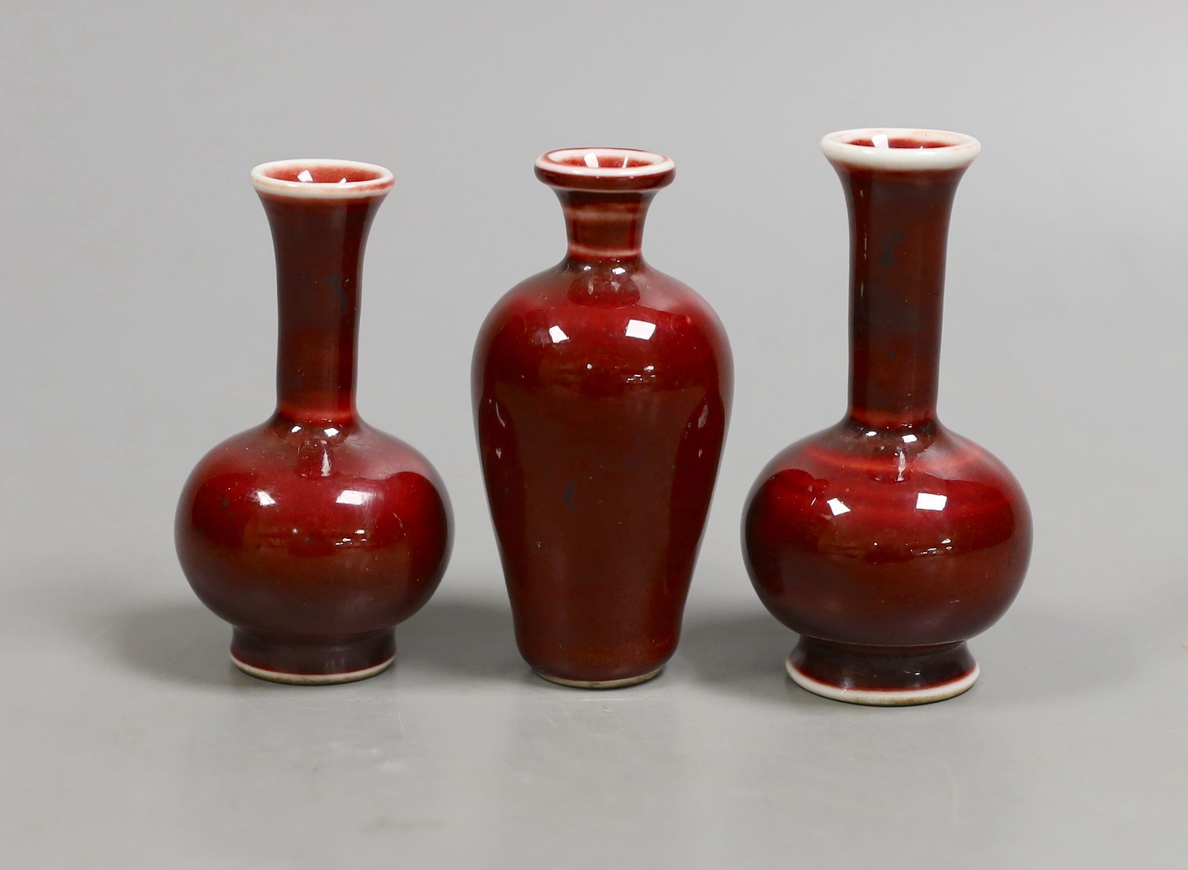 Three Chinese miniature sang-de-boeuf vases, tallest 8 cms high.